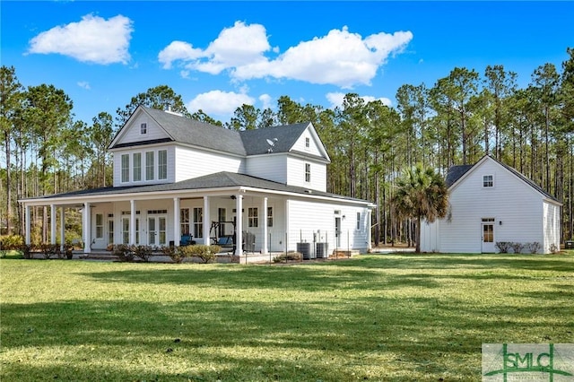 back of property with cooling unit, a porch, and a lawn