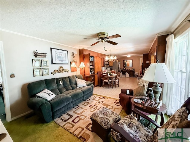 living room with a textured ceiling, ornamental molding, and ceiling fan with notable chandelier