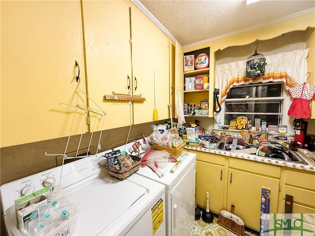 laundry area featuring laundry area, a textured ceiling, and washing machine and clothes dryer