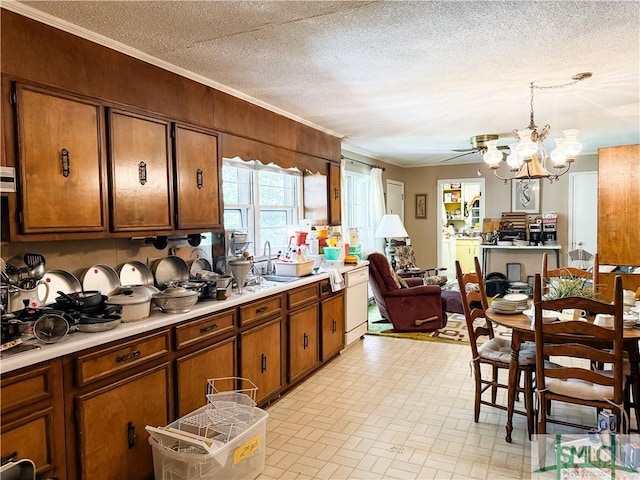 kitchen featuring brown cabinetry, a textured ceiling, light countertops, and dishwasher