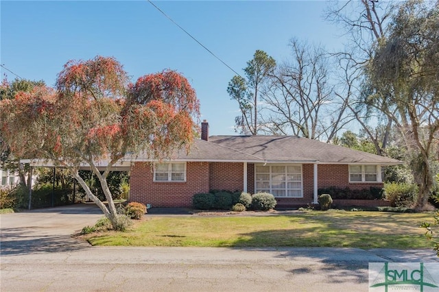 ranch-style home featuring concrete driveway, brick siding, a chimney, and a front lawn