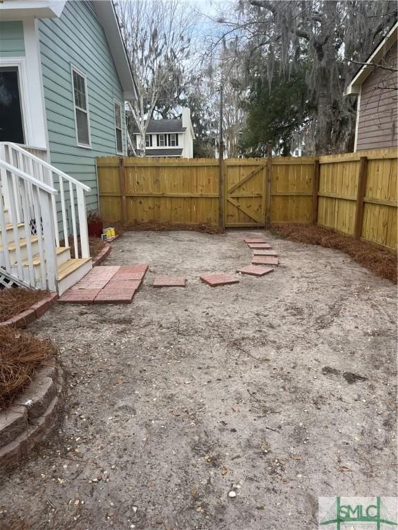 view of yard with fence and a gate