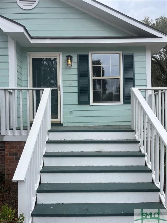 doorway to property with a porch