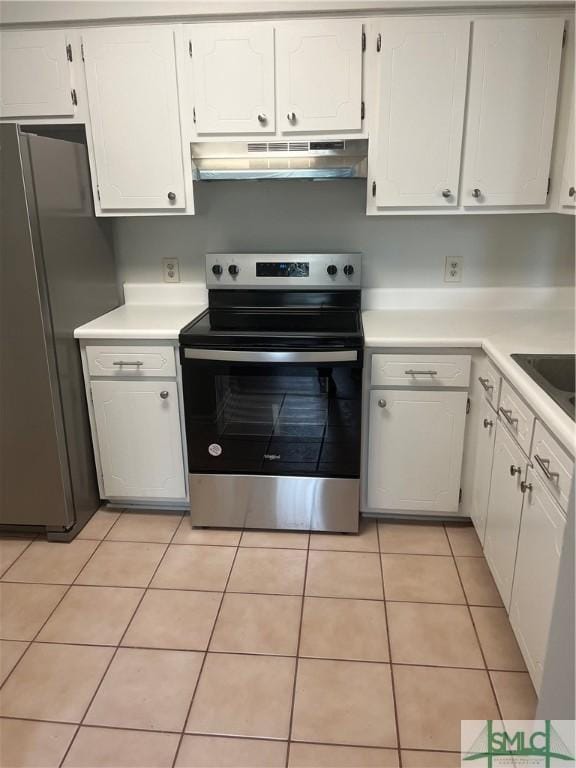 kitchen featuring light tile patterned floors, under cabinet range hood, stainless steel appliances, white cabinetry, and light countertops