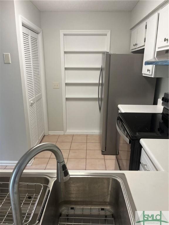 kitchen featuring black / electric stove, extractor fan, white cabinetry, a sink, and light tile patterned flooring