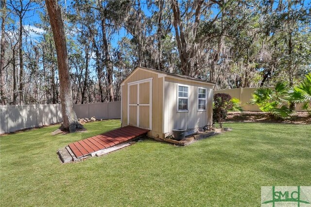 view of shed with a fenced backyard