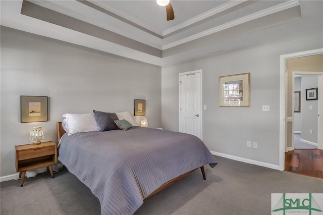 bedroom featuring a raised ceiling, carpet flooring, crown molding, and baseboards