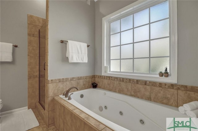 bathroom featuring toilet, a stall shower, and a tub with jets