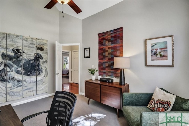 sitting room with ceiling fan, carpet flooring, and baseboards