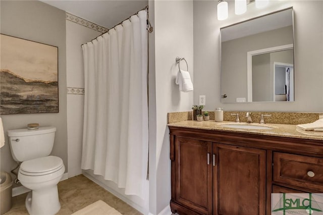 bathroom featuring curtained shower, vanity, and toilet