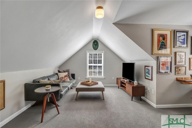 living area featuring vaulted ceiling, carpet floors, and baseboards