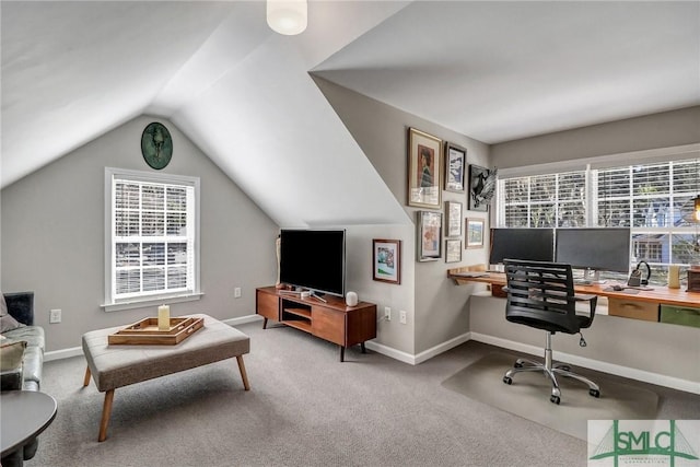 carpeted office featuring vaulted ceiling, a wealth of natural light, and baseboards