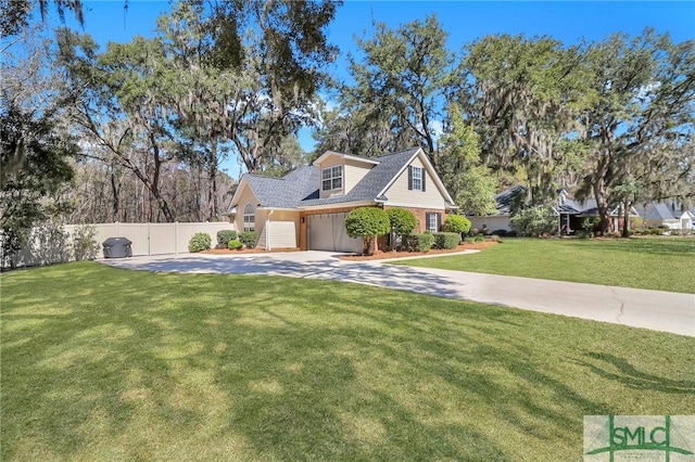 view of front of home featuring a garage, fence, driveway, and a front lawn