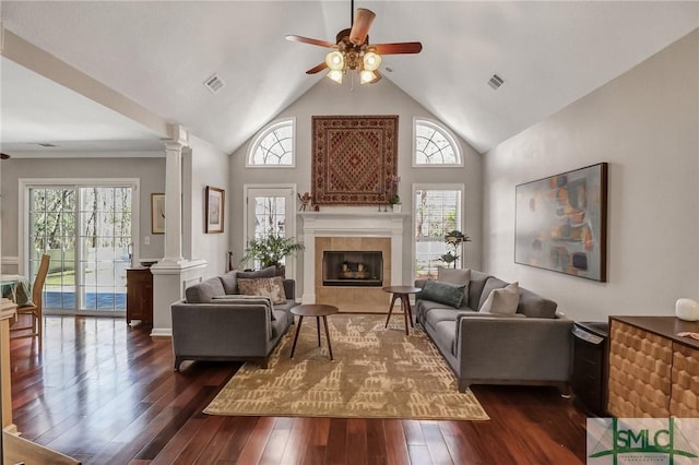 living room with a ceiling fan, decorative columns, visible vents, and dark wood-style flooring