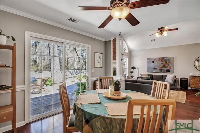 dining area with crown molding, dark wood finished floors, visible vents, and ornate columns