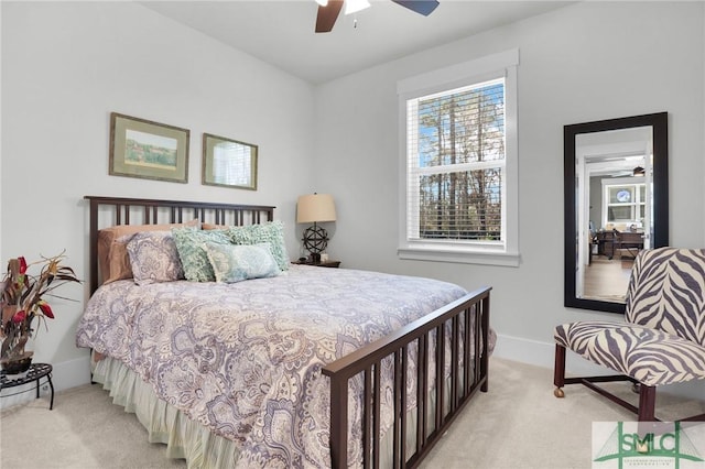 bedroom with ceiling fan, baseboards, and light colored carpet