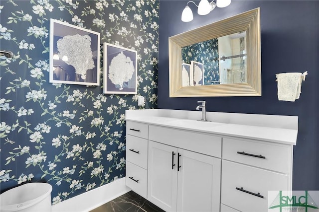 bathroom with marble finish floor and vanity