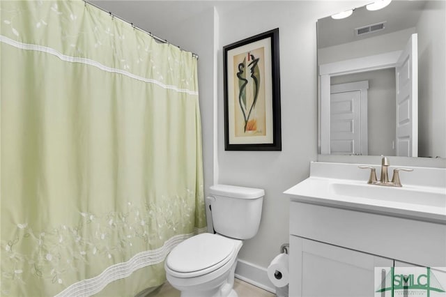 bathroom featuring baseboards, visible vents, vanity, and toilet