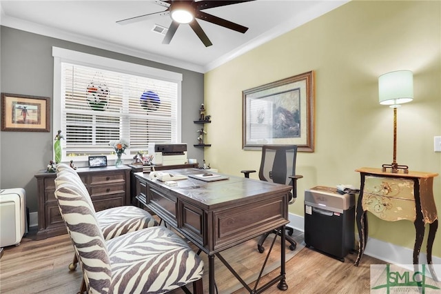 home office featuring visible vents, crown molding, light wood finished floors, and ceiling fan