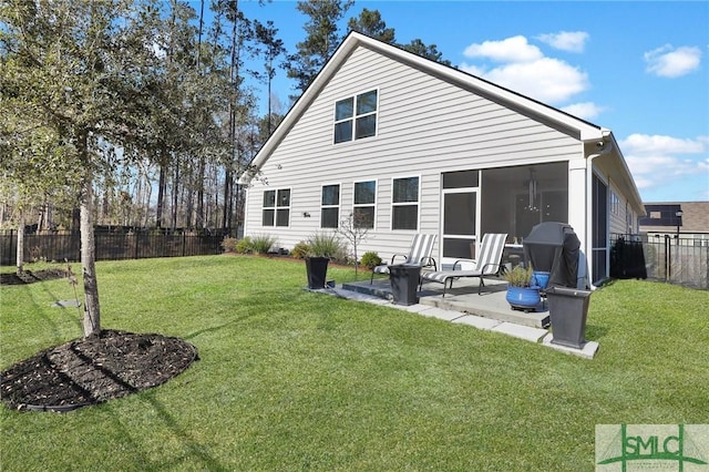 back of property with fence private yard, a patio area, a sunroom, and a lawn