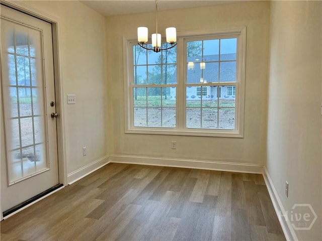 906 Coosa Cv, Ellabell, GA 31308 - unfurnished dining area featuring a chandelier and dark wood-style flooring