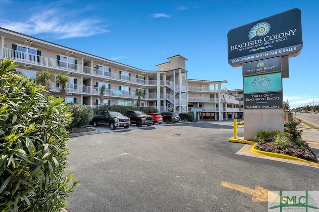 view of building exterior featuring uncovered parking