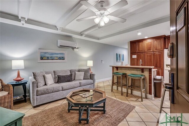 living room featuring ceiling fan, beamed ceiling, a wall mounted air conditioner, light tile patterned floors, and wet bar