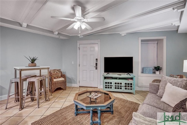 living room with tile patterned floors, beamed ceiling, baseboards, and ceiling fan