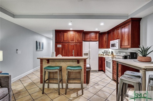 kitchen featuring light tile patterned flooring, dark brown cabinets, white appliances, and a kitchen island