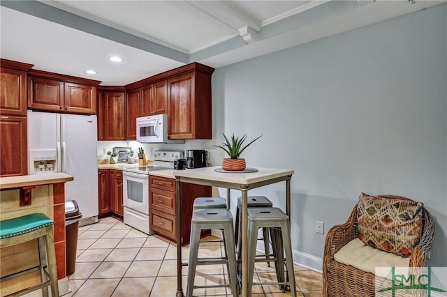 kitchen featuring light tile patterned floors, white appliances, recessed lighting, and light countertops