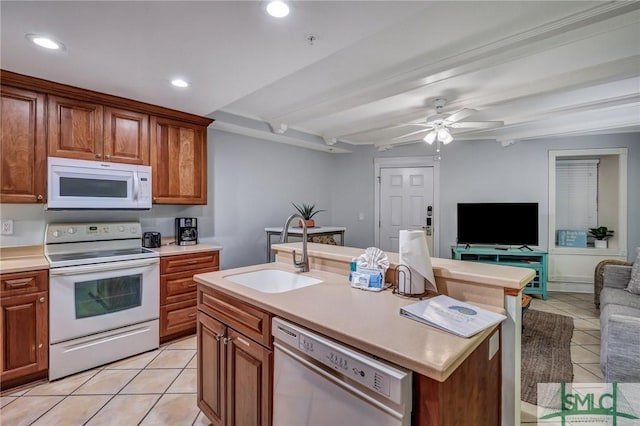 kitchen featuring white appliances, light tile patterned floors, a sink, light countertops, and open floor plan