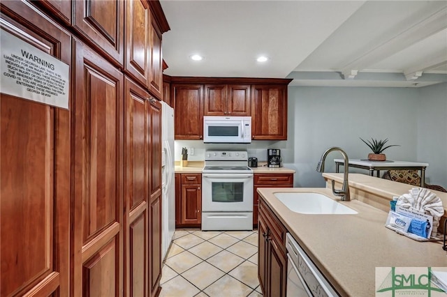 kitchen featuring white appliances, light tile patterned floors, recessed lighting, a sink, and light countertops