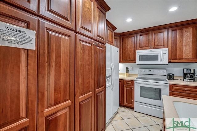 kitchen featuring light countertops, light tile patterned floors, recessed lighting, brown cabinetry, and white appliances