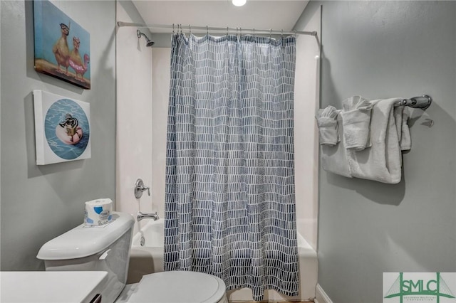 bathroom featuring toilet and shower / tub combo