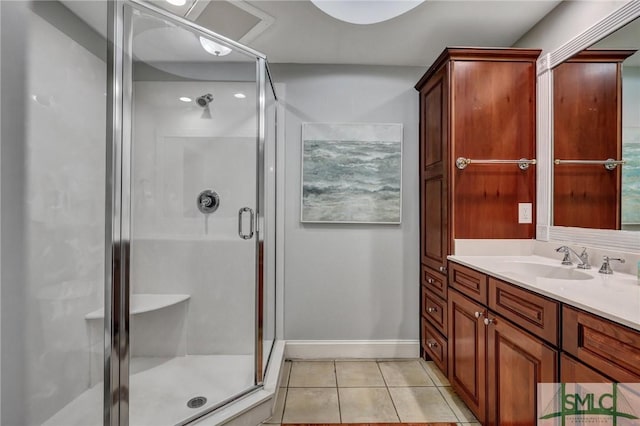 bathroom with tile patterned flooring, a stall shower, vanity, and baseboards