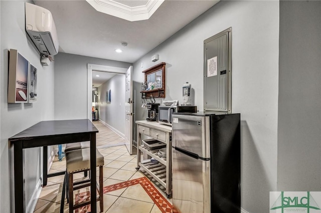 kitchen with a wall unit AC, light tile patterned floors, baseboards, recessed lighting, and freestanding refrigerator