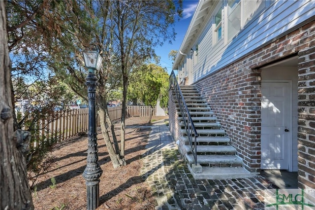 view of yard featuring fence private yard and stairway