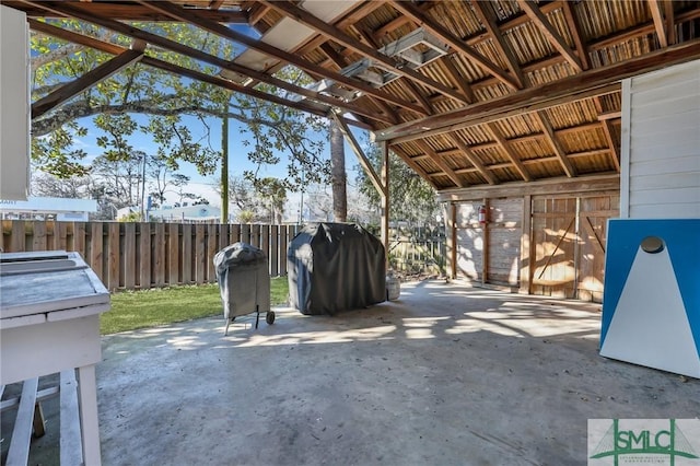 view of patio with an outbuilding, an exterior structure, and a grill