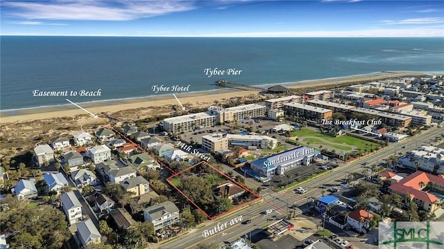 drone / aerial view with a water view and a beach view