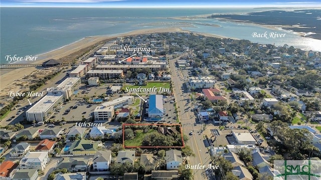 bird's eye view featuring a water view and a view of the beach