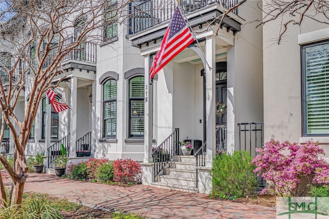 doorway to property featuring stucco siding