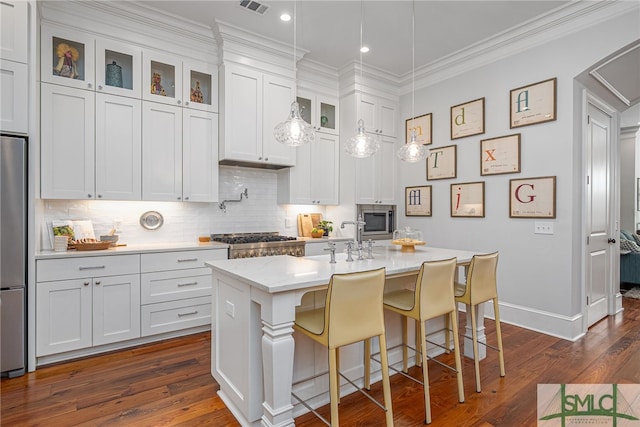 kitchen with decorative backsplash, glass insert cabinets, appliances with stainless steel finishes, dark wood-type flooring, and crown molding