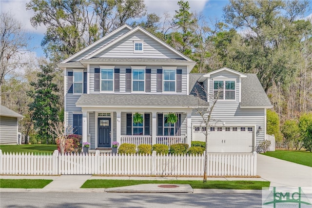 traditional-style home with a fenced front yard, covered porch, driveway, and a shingled roof