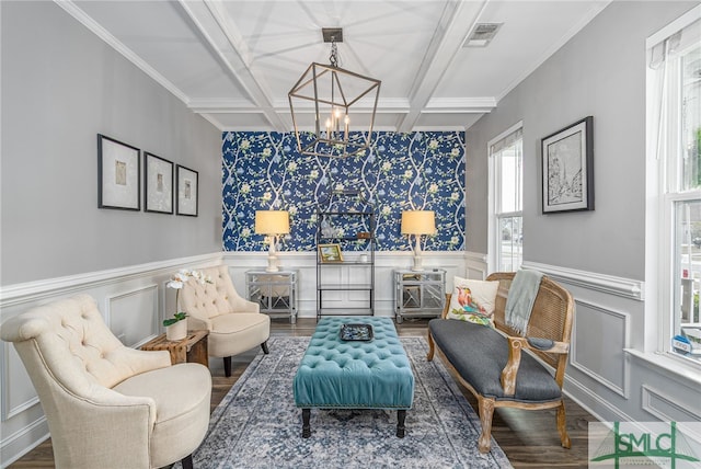 living area featuring beam ceiling, visible vents, wainscoting, wood finished floors, and coffered ceiling