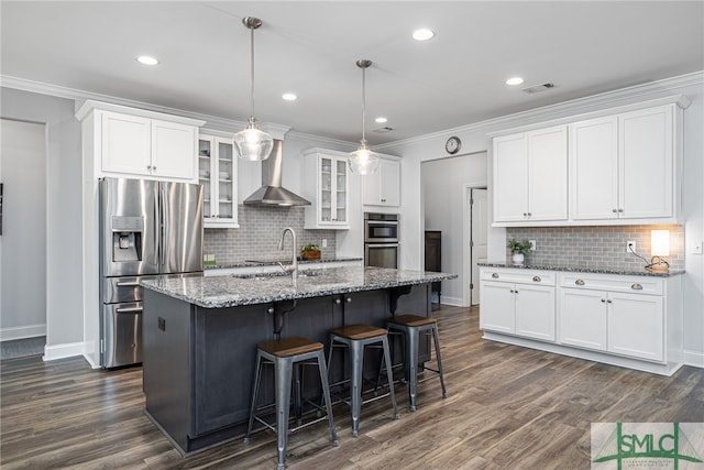 kitchen with wall chimney exhaust hood, crown molding, stainless steel appliances, and a sink