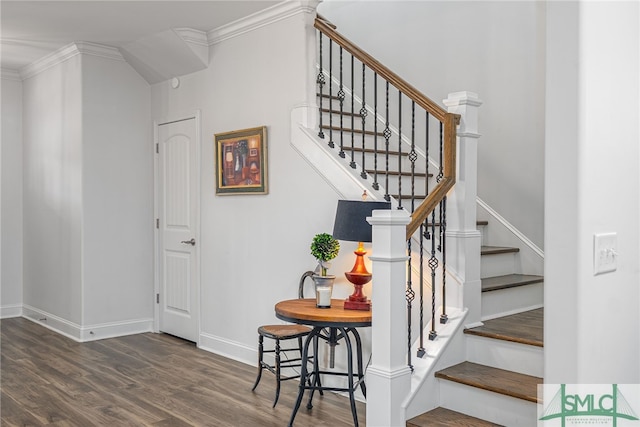 stairs featuring crown molding, wood finished floors, and baseboards