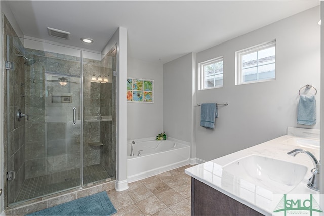 full bath featuring a garden tub, double vanity, visible vents, a stall shower, and a sink