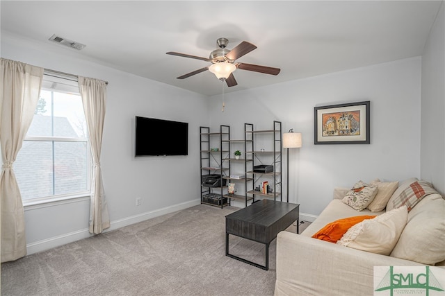 living area featuring a ceiling fan, carpet, visible vents, and baseboards