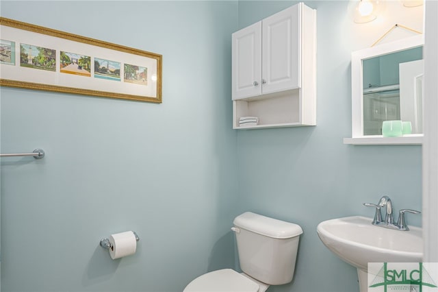 bathroom featuring toilet and a sink