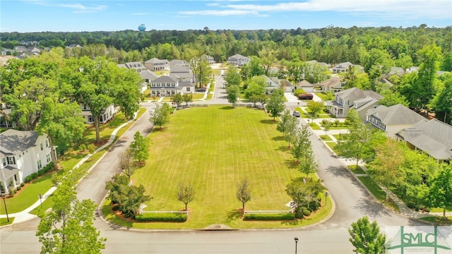 birds eye view of property with a forest view and a residential view